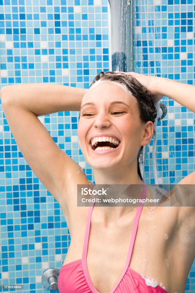 Woman showering "Woman showering, hands in hair,canon 1Ds mark III" Blue Stock Photo