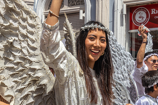 Cuenca, Ecuador - December 24, 2022: Pase del Niño Viajero (The Traveling Child) Christmas Parade, UNESCO Cultural Heritage. A beautiful woman in the form of an Angel greets the audience. Cuenca
