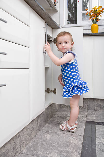 istock Baby girl standing in a kitchen 173594491