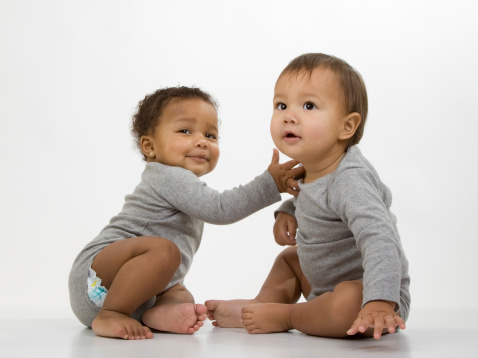 Baby boy and girl on a white background. For more babies