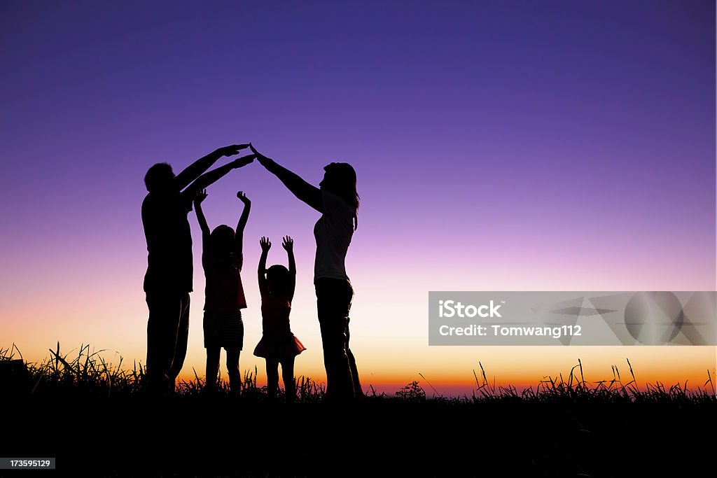 happy family making the home sign happy family making the home sign on the hill Family Stock Photo