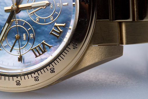 A gold wrist watch.