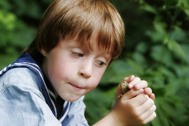 istock Little Boy and Frog Up Close 173595841