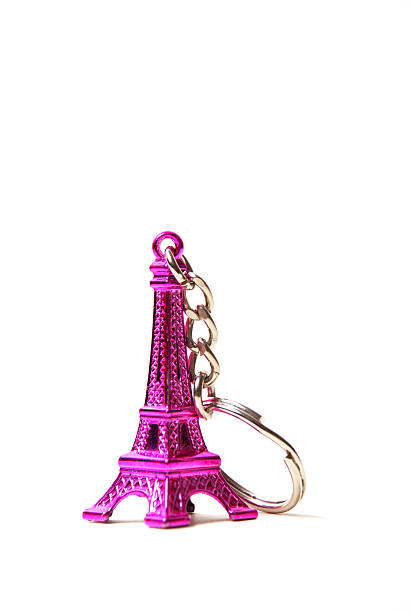 Eiffel tower keyring Macro shot of an Eiffel tower keyring in pink keyring charm stock pictures, royalty-free photos & images