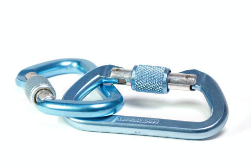 Horizontal photo of two blue carabiners