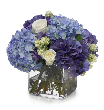 Hydrangea and rose bouquet in glass cube with reflection. The image has an embedded path to delete the reflection if desired. This arrangement was shot against a bright white background. Extremely high quality faux flowers.