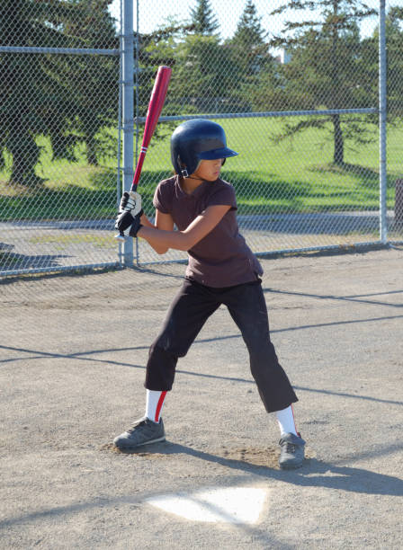 istock Young girl in baseball batting stance 173596943