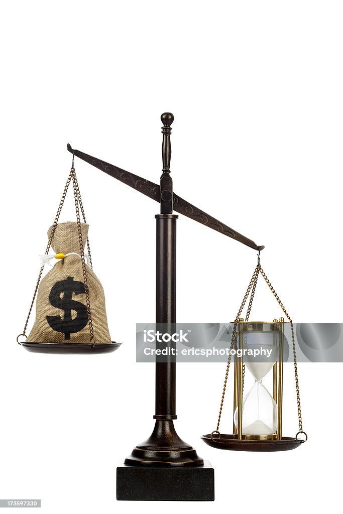 Value of time Hourglass and bag of money on scale. White background. Close-up Stock Photo