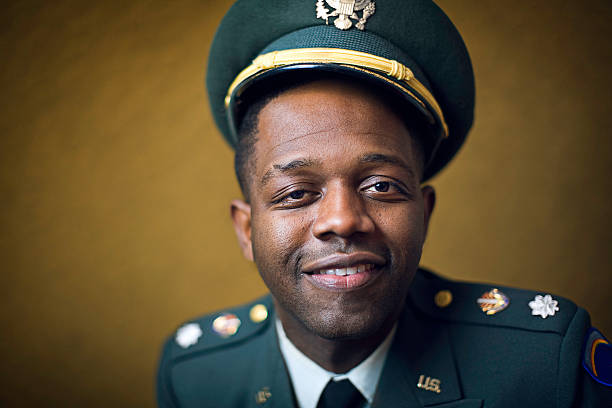 A decorated United Statesmilitary man, in full dress with a pleasant happy smile.  Horizontal with copy space.