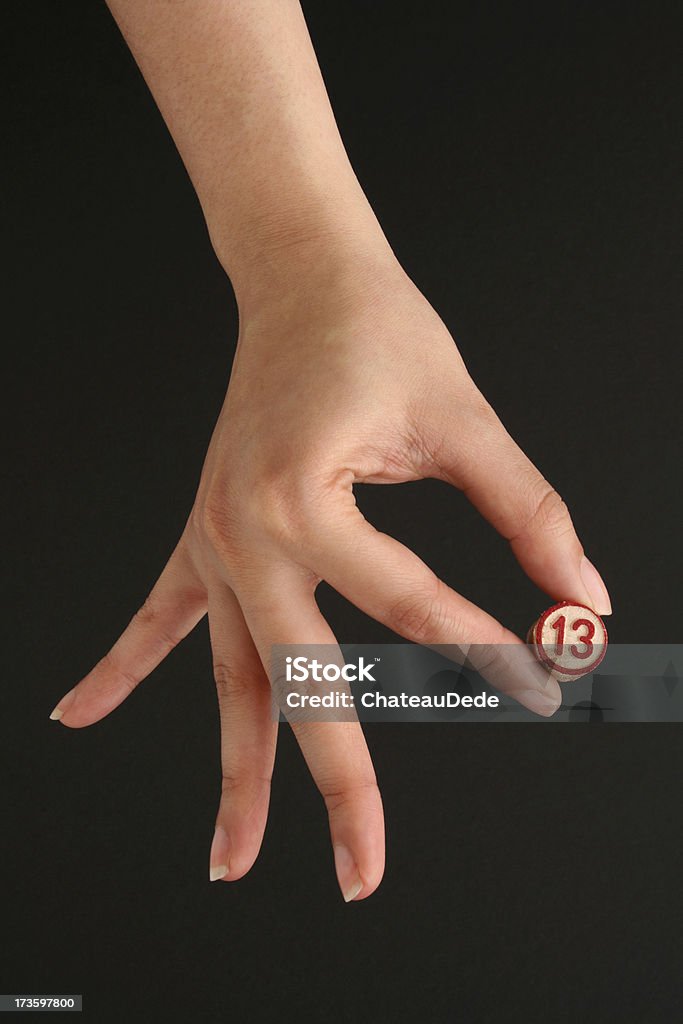 Number 13 Top view of woman hand holding number 13. Adult Stock Photo