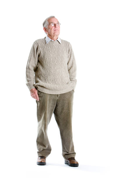 seniors: contemplation "A thoughtful stance from a handsome senior gentleman. Full body, studio shot isolated on white." worried man standing stock pictures, royalty-free photos & images