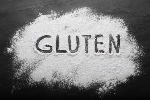 istock Word Gluten written with flour on black table, top view 1735981302
