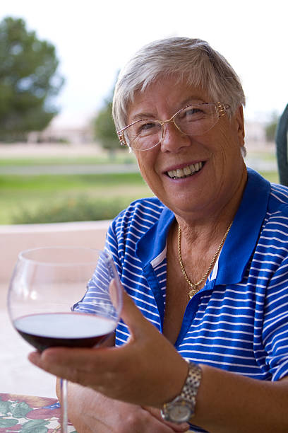 Senior woman enjoying wine stock photo
