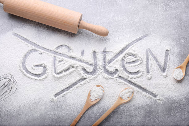 istock Crossed out word Gluten and different kitchen utensils on grey background, flat lay 1735982966