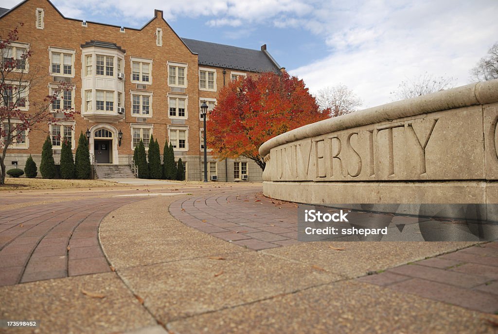 University in Autumn University sign and building Campus Stock Photo
