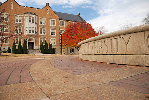 University in Autumn University sign and building college stock pictures, royalty-free photos & images