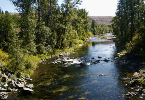 A small stream flowing through barren arid land