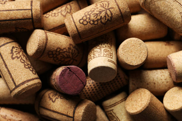 istock Many corks of wine bottles with grape images as background, closeup 1735989515