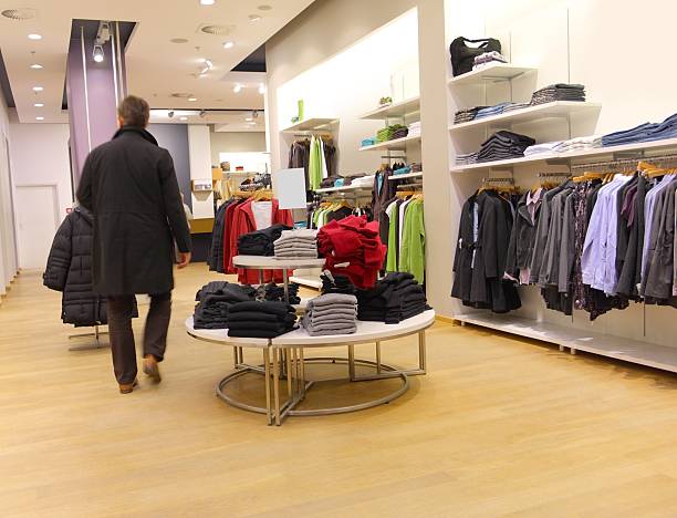 istock Man walking through clothing store 173599436