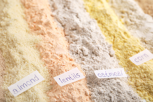 Different types of flours as background, closeup