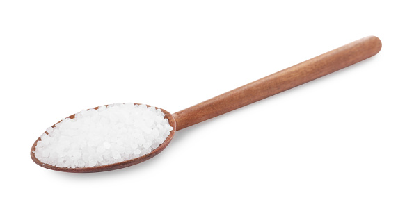 Wooden spoon with natural sea salt isolated on white