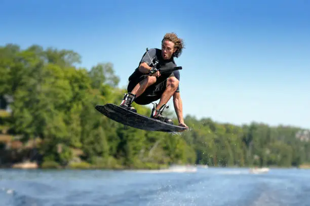 A man in the middle of a jump while wakeboarding. Adobe RGB color profile.