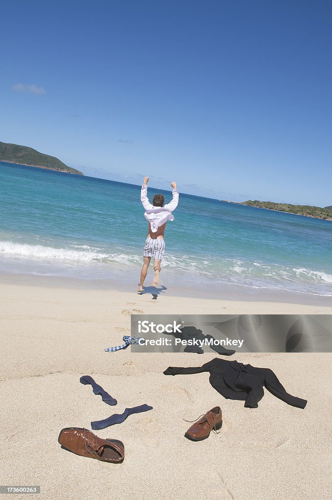 Businessman Loses His Suit "Businessman loses his suit, along with his shoes, socks, and tie on his way down to the beach" Activity Stock Photo