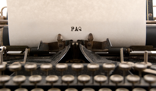The acronym FAQ as shown to have been typed on a vintage typewriter... copy space.