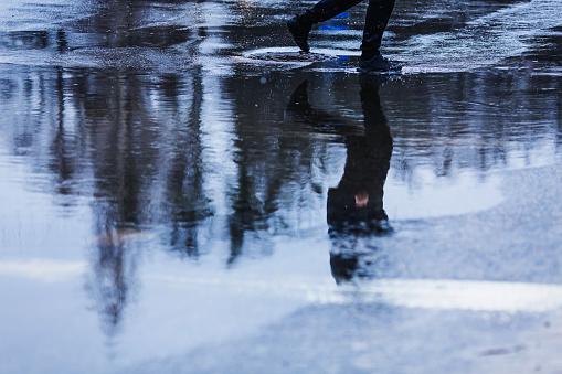 Puddle on asphalt. Rainy weather.