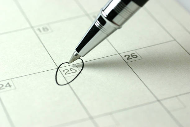 It's Christmas! A pen marked the 25th day on the calendar. calendar date circled stock pictures, royalty-free photos & images