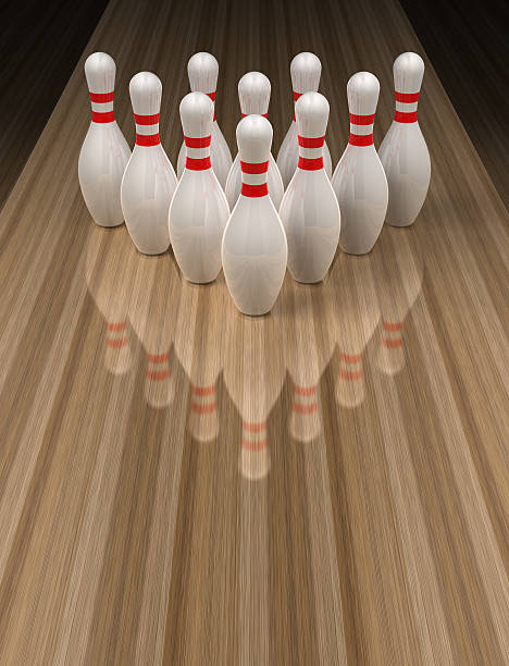 Bowling pins on wooden bowling alley Ten bowling pins lined up perfectly on a bowling lane. bowling alley wood stock pictures, royalty-free photos & images
