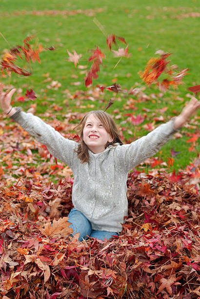 istock Girl Throwing Leaves 173601861