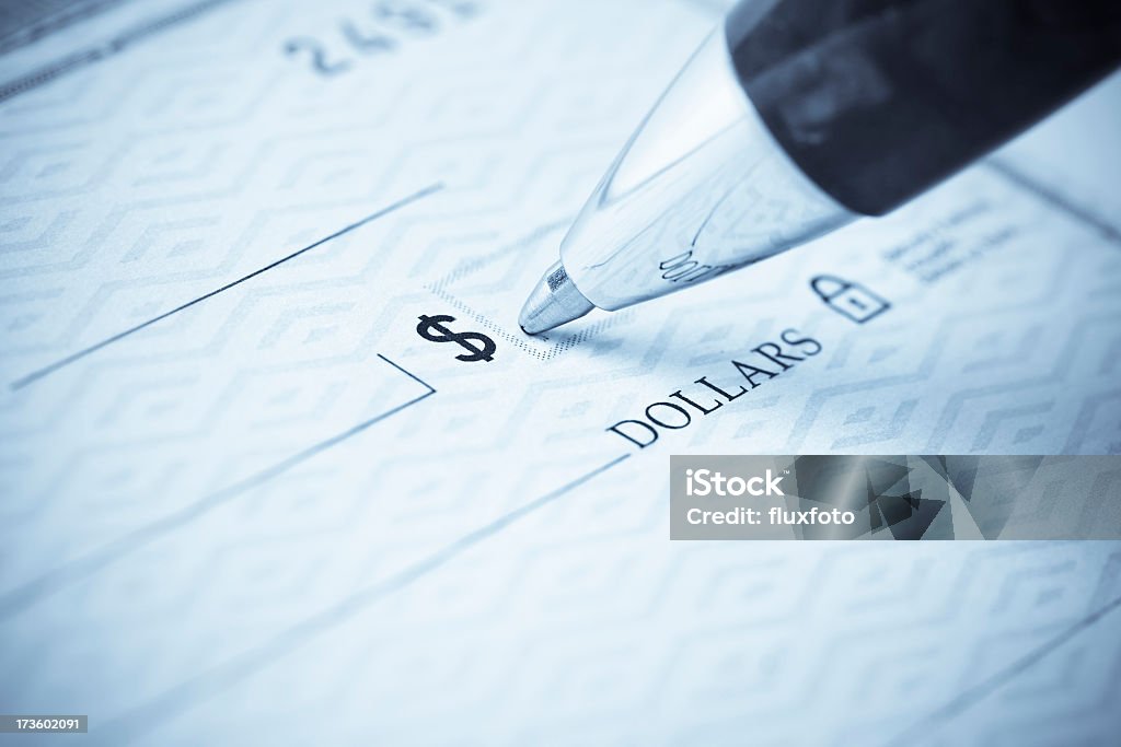 Pen being used to write a check Writing a check.  Please visit my lightbox for more similar photos Check - Financial Item Stock Photo