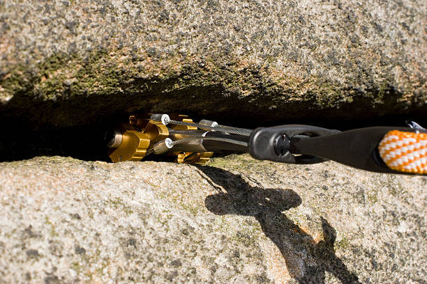 A camming device placed in a crack in the rock