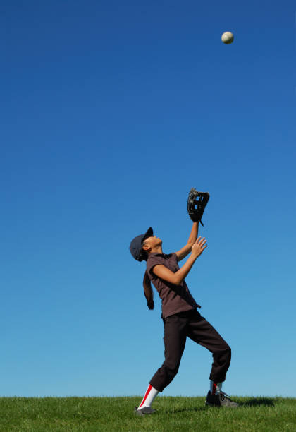 istock Young girl catching a fly ball 173603514