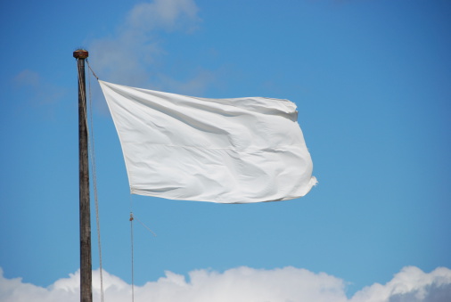 White flag against blue sky.