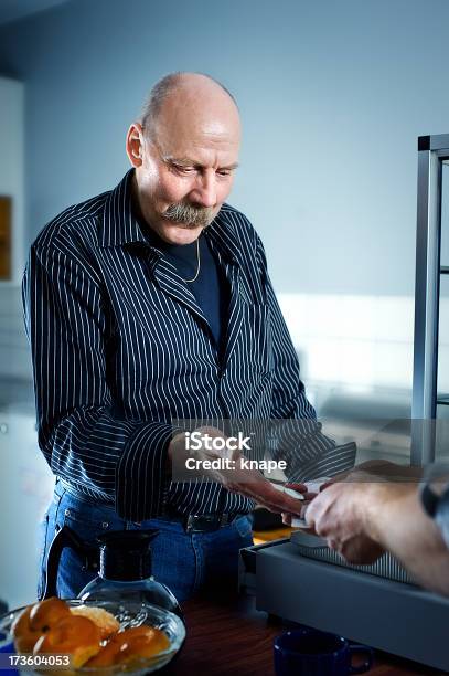 Active Senior Working In A Small Cafeteriacafe Stock Photo - Download Image Now - 60-69 Years, 65-69 Years, 70-79 Years