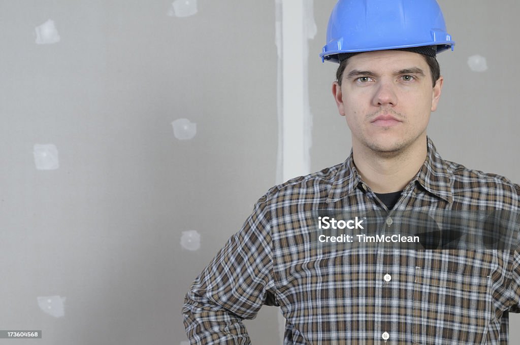 The  Handyman builder standing with a construction helmet onhandyman with a hammerHere's more in my lightbox Adult Stock Photo