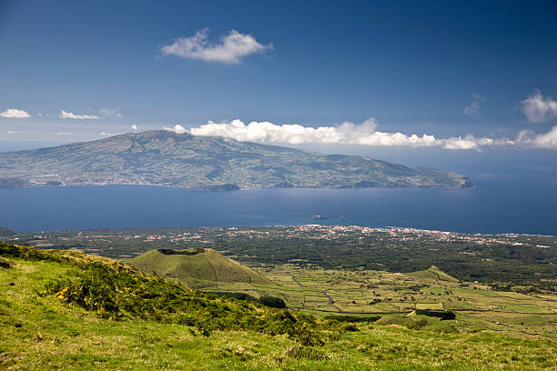 Faial Island View Azores Islands View over the village of Madalena to Faial Island (Neighbor Island of Pico) down from Mount Pico on Pico Islands. Beautiful view over green landscape to the volcanic islands in the atlantic ocean. Azores Islands. madalena stock pictures, royalty-free photos & images