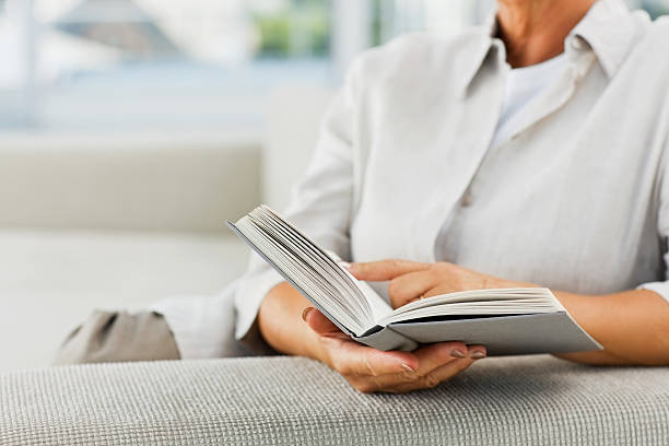 istock Midsection of a woman reading book 173605332