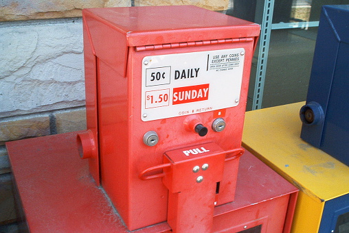 Coin operated newspaper vending machine