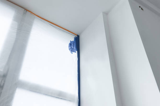 istock Window covered by plastic film and insulation tape indoors, low angle view 1736056106
