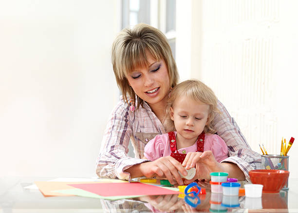 istock Mom and daughter playing together 173605614