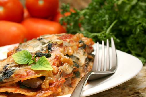 Whole wheat vegetarian lasagna with spinach, mushrooms and onions.