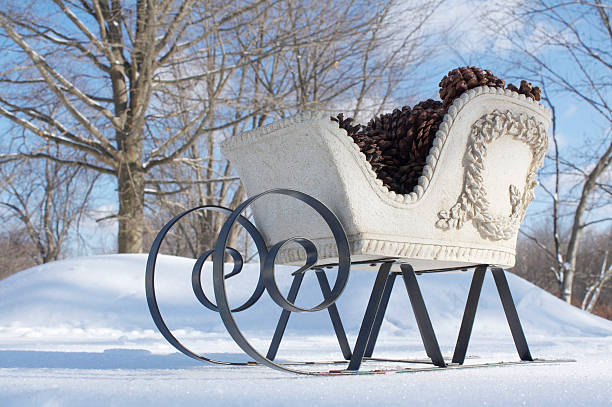 Closeup of a vintage wooden sled with rope handle in snow.  Wooden sled on a snowy background.  Classic winter scene. Winter nostalgia, outdoor play, and rustic seasonal adventures.