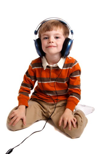 Cute little boy listening to music in his headphones