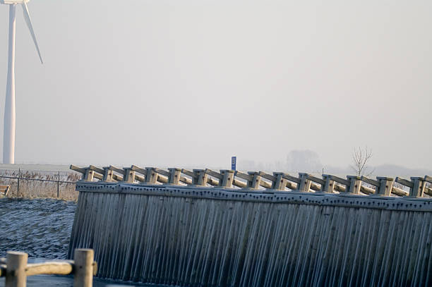 istock Wooden structure along the water & Wind Turbine 173606184