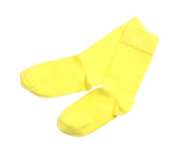 istock Pair of yellow socks on white background, top view 1736063066
