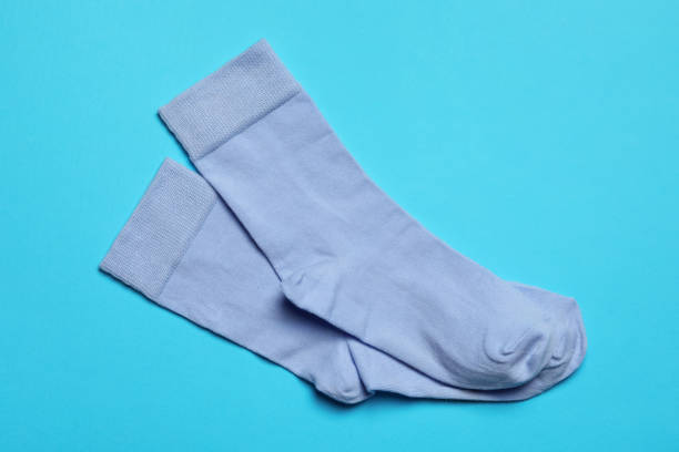 istock Pair of new socks on light blue background, flat lay 1736064040