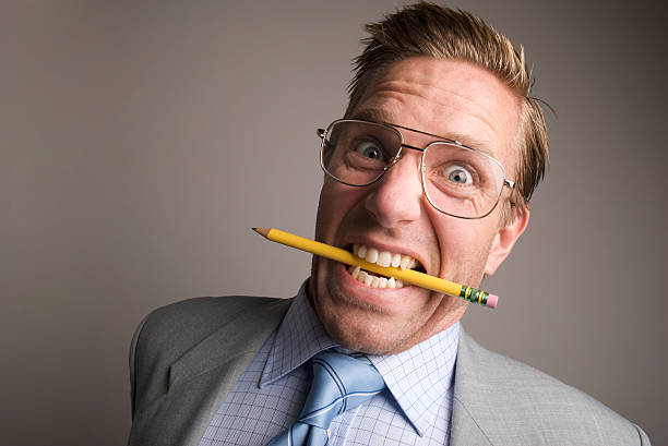 istock Stressed-Out Businessman Bites Pencil 173606963